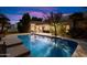 Stunning nighttime view of the home's backyard pool at 10232 N 54Th Pl, Paradise Valley, AZ 85253