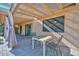 Covered patio with pergola, table, chairs and curtains at 10405 N 65Th Dr, Glendale, AZ 85302