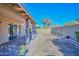 Covered patio with pavers and curtains, overlooking a grassy backyard at 10405 N 65Th Dr, Glendale, AZ 85302