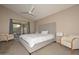 Bright bedroom featuring a king-size bed and access to a private patio at 10405 N 65Th Dr, Glendale, AZ 85302