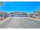 Gated community entrance with paved road and flag at 10405 N 65Th Dr, Glendale, AZ 85302