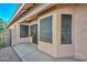 Home's side entrance with a screened window and gated entry at 10405 N 65Th Dr, Glendale, AZ 85302