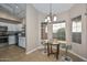 Eat-in kitchen boasting a bay window and stylish chandelier at 10405 N 65Th Dr, Glendale, AZ 85302