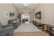 Spacious living room featuring a large TV, comfy seating, and a beautiful chandelier at 10405 N 65Th Dr, Glendale, AZ 85302