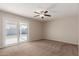 Spacious bedroom with carpet flooring and sliding glass door to backyard at 11021 W Monterosa St, Phoenix, AZ 85037