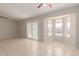 Living room with bay window and sliding glass doors leading to the backyard at 11021 W Monterosa St, Phoenix, AZ 85037