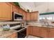 Kitchen corner detail with granite countertops and wooden cabinets at 14778 S Oakmont Dr, Arizona City, AZ 85123