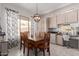 Bright dining area with wooden table and chairs, adjacent to kitchen at 14806 E Crested Crown --, Fountain Hills, AZ 85268