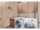 Laundry room with LG washer and dryer and wood cabinets at 14849 E Valley Vista Dr, Fountain Hills, AZ 85268