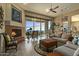 Living room with fireplace, large windows, and patio access, offering scenic views at 14849 E Valley Vista Dr, Fountain Hills, AZ 85268