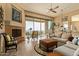 Living room with fireplace, large windows, and patio access, offering scenic views at 14849 E Valley Vista Dr, Fountain Hills, AZ 85268