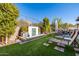 Landscaped backyard oasis with a water feature and comfortable lounge chairs at 21122 W Edgemont Ave, Buckeye, AZ 85396