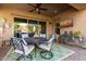 Covered patio with dining area and comfortable seating for outdoor entertaining at 21122 W Edgemont Ave, Buckeye, AZ 85396