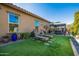 Artificial turf backyard with lounge chairs and gazebo at 21122 W Edgemont Ave, Buckeye, AZ 85396