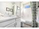 Clean bathroom with white vanity, bathtub and shower combo at 21122 W Edgemont Ave, Buckeye, AZ 85396