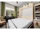 Bedroom with murphy bed and built-in shelving at 21122 W Edgemont Ave, Buckeye, AZ 85396