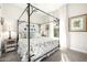 Bedroom with canopy bed, decorative dresser and large window at 21122 W Edgemont Ave, Buckeye, AZ 85396
