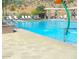 Inviting community pool with lounge chairs and a play feature at 21122 W Edgemont Ave, Buckeye, AZ 85396