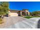 Tan house with a three-car garage and artificial turf at 21122 W Edgemont Ave, Buckeye, AZ 85396