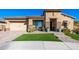 Beautiful home with tan exterior, landscaped yard and a three-car garage at 21122 W Edgemont Ave, Buckeye, AZ 85396