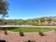 Scenic golf course view with a pond and mountains at 21122 W Edgemont Ave, Buckeye, AZ 85396