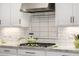 Kitchen details featuring gas cooktop and decorative backsplash at 21122 W Edgemont Ave, Buckeye, AZ 85396