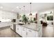 Open concept kitchen with large island, stainless steel appliances, and white cabinets at 21122 W Edgemont Ave, Buckeye, AZ 85396