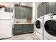 Bright laundry room with washer, dryer, and ample cabinet space at 21122 W Edgemont Ave, Buckeye, AZ 85396