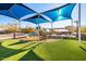 Community playground with shade structures and climbing wall at 21122 W Edgemont Ave, Buckeye, AZ 85396