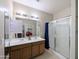 Double vanity bathroom with a large glass shower at 21209 N 40Th Ave, Glendale, AZ 85308