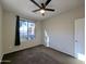 Spacious bedroom featuring a ceiling fan and large window at 21209 N 40Th Ave, Glendale, AZ 85308