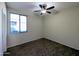 Bedroom with ceiling fan and large window at 21209 N 40Th Ave, Glendale, AZ 85308