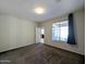 Well-lit bedroom with carpet flooring and door to patio at 21209 N 40Th Ave, Glendale, AZ 85308