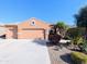 Single-story house with a two-car garage and desert landscaping at 21209 N 40Th Ave, Glendale, AZ 85308