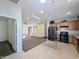 Open concept kitchen with island and views into living room at 21209 N 40Th Ave, Glendale, AZ 85308