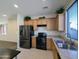 Well-equipped kitchen with stainless steel appliances and wood cabinets at 21209 N 40Th Ave, Glendale, AZ 85308