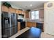 Modern kitchen featuring stainless steel appliances and wood cabinets at 21209 N 40Th Ave, Glendale, AZ 85308