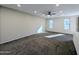 Bright living room featuring carpet and ceiling fan at 21209 N 40Th Ave, Glendale, AZ 85308