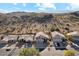 Residential street featuring well-maintained homes with desert landscapes, nestled against a mountain range at 2249 E Taxidea Way, Phoenix, AZ 85048