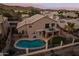 Aerial view of the backyard featuring a pool, balcony, patio, and artificial grass at 2249 E Taxidea Way, Phoenix, AZ 85048