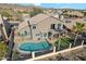 Aerial view of a home's backyard with a pool, artificial turf, and outdoor seating area at 2249 E Taxidea Way, Phoenix, AZ 85048