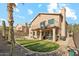 Beautiful backyard with green lawn, desert landscaping, and a patio at 2249 E Taxidea Way, Phoenix, AZ 85048