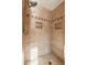 Elegant bathroom shower featuring tile surround, soap niches and designer tile accent at 2249 E Taxidea Way, Phoenix, AZ 85048