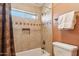 Bathroom shower featuring tile surround, soap niche, and designer tile accent at 2249 E Taxidea Way, Phoenix, AZ 85048