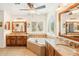 Bright bathroom with dual vanities, soaking tub, shuttered window, and ceiling fan at 2249 E Taxidea Way, Phoenix, AZ 85048