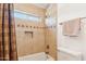 Bathroom with shower and tub with decorative tile detail and towel racks at 2249 E Taxidea Way, Phoenix, AZ 85048
