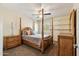 Comfortable bedroom featuring a four poster bed, ceiling fan and shutters at 2249 E Taxidea Way, Phoenix, AZ 85048