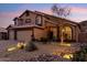 Two-story home with three-car garage and desert landscaping featuring rocks and cactuses at 2249 E Taxidea Way, Phoenix, AZ 85048