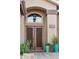 Close-up of the home's double front door with stylish fixtures and planters at 2249 E Taxidea Way, Phoenix, AZ 85048
