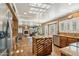 Open-concept kitchen featuring an island, stainless steel appliances, and a seamless flow into the living area at 2249 E Taxidea Way, Phoenix, AZ 85048